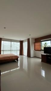 a large room with a bed and a large window at Apartment in Koh Samui