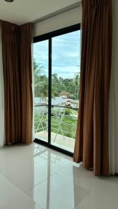 a room with a large window with a view of the ocean at Apartment in Koh Samui
