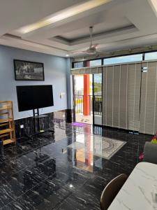 a living room with a flat screen tv on a wall at S & D Guesthouse in Kampot