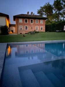 a large swimming pool in front of a house at B&B Cascina Gaione Via Gallina,18b 12052 Neive cn in Neive