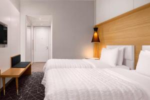 Postel nebo postele na pokoji v ubytování Le Meridien Visconti Rome