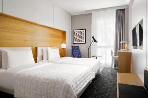 Postel nebo postele na pokoji v ubytování Le Meridien Visconti Rome