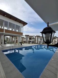 a large swimming pool in front of a building at Vacation Home near Panglao Airport and White Sand Beaches in Biking