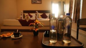 two bottles sitting on a tray on a table at Hotel MountView Comforts in Tirupati