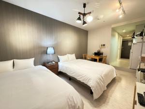 Postel nebo postele na pokoji v ubytování マルチステイ大阪天満