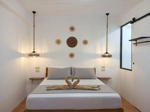 a bedroom with a bed with a ribbon on it at New studio General Luna in General Luna