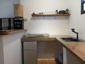 a kitchen with a stove and a counter top at New studio General Luna in General Luna
