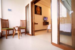 a dining room with a table and chairs in a room at Villa Sammy in Seminyak