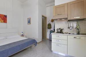 a kitchen with a bed and a sink in a room at Residence Baia D'Oro in Torre Mozza