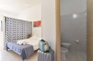 a bedroom with a bed and a toilet and a shower at Residence Baia D'Oro in Torre Mozza +30 photos