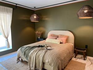 a bedroom with a bed with a cat sitting on it at Cozy beach house Jurmala II in Jūrmala