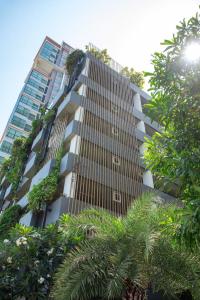 a tall building with plants on the side of it at Suvarnabhumi Airport , Bangkok , Sukumvit ,Bts Ekamai-Bangna in Amphoe Phra Khanong