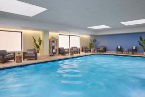 a pool in a hotel room with chairs and tables at Washington Marriott at Metro Center in Washington