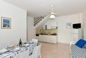 a dining room with a table and chairs at Residence Baia D'Oro in Torre Mozza