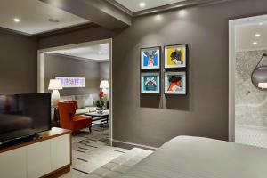 a hotel room with a bed and a living room at London Marriott Hotel County Hall in London