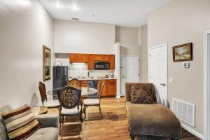 a living room with a couch and a table at Grand Wood Suites - 3rd Floor Back Side Penthouse Suite 307 in Nashville