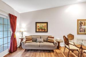 a living room with a couch and a table at Grand Wood Suites - 3rd Floor Back Side Penthouse Suite 307 in Nashville +9 photos