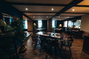 a restaurant with tables and chairs and a clock on the wall at The Kings Head, Usk in Usk