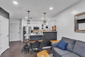 a living room with a couch and a kitchen at Grand Wood Suites - 2nd Floor Front Side Signature Suite 201 in Nashville +10 photos