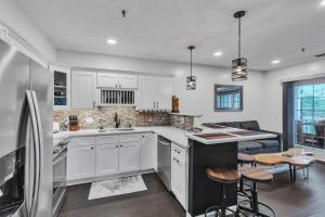 a kitchen with white cabinets and a counter top at Grand Wood Suites - 2nd Floor Front Side Signature Suite 201 in Nashville
