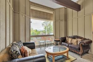 a living room with a leather couch and a coffee table at Grand Wood Suites - 1st Floor Front Side Suite 104 in Nashville