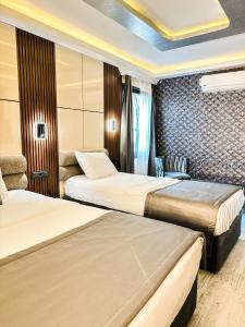 a hotel room with two beds and a chair at the Amara Hotel in Istanbul