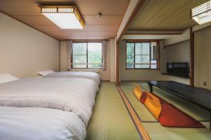 Krevet ili kreveti u jedinici u okviru objekta Takamiya Hotel Hammond