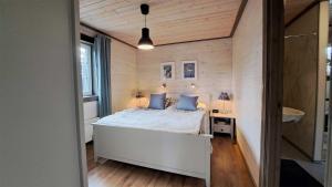 a bedroom with a bed with blue pillows at Falkstigen 5, Messlingen in Messlingen