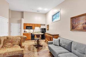 a living room with a couch and a table at Grand Wood Suites - 3rd Floor Back Side Corner Penthouse Suite 308 in Nashville +7 photos