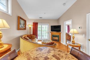 a living room with a table and a fireplace at Grand Wood Suites - 3rd Floor Front Side Corner Penthouse Suite 301 in Nashville +11 photos