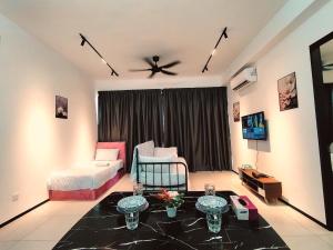 a living room with a bed and a ceiling fan at Georgetown Classic Collection 3BR-10PAX in George Town +61 photos