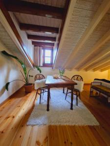 a living room with a wooden table and chairs at Hospederia Santillana in Santillana del Mar