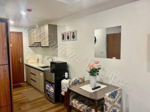 a kitchen with a table and a kitchen with a counter at 'Highland Escape' Condo Studio Unit in Baguio
