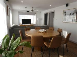 a living room with a table and a couch at Moonta Bay Stylish large home 3 min walk from beach and jetty in Port Moonta