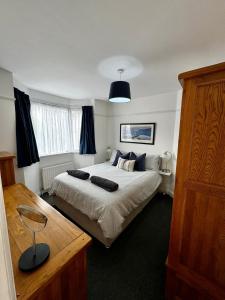 a bedroom with a large bed in a room at Seaside town bungalow Herne Bay Kent in Kent