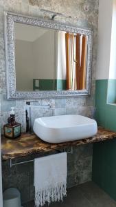a bathroom with a white sink and a mirror at Villa Carmela in Martina Franca