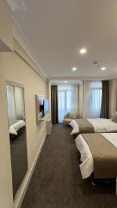 a hotel room with three beds and a mirror at Espoir HOTEL in Istanbul +89 photos