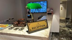 a sign sitting on top of a table with a green lamp at Espoir HOTEL in Istanbul