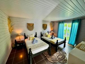 Postel nebo postele na pokoji v ubytování Fare One Island Moorea