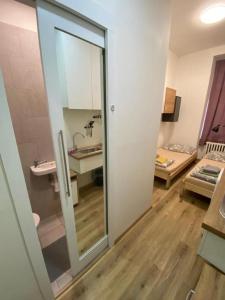 a room with a bathroom with a sink and a mirror at Red&Black Apartment City centr, Na Hradbách 118 in Ostrava