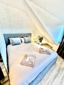 a bed with two pillows on it in a room at PANORAMA APARTMENT in Montana