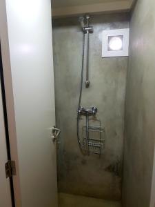 a shower stall in a bathroom with a toilet at Conde Surf Camp - Capsule Beds FEMALE Dorm in Vila do Conde +20 photos