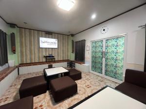 a waiting room with a waiting table and chairs at Suanpai Resort Sattahip in Sattahip