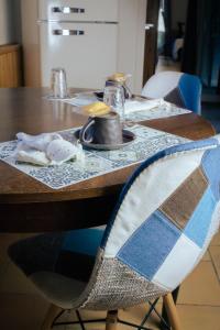 a wooden table with a blue and white table cloth on it at Le poulailler de Montgilbert in Aiguebelle +21 photos