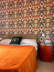 a bedroom with a bed with a floral wallpaper at Domus Orestea Luxury Suites in Palermo
