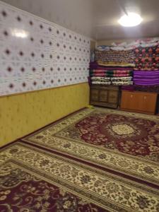 a room with a bunch of rugs on the floor at Ак калпак in Kalday