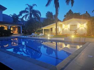 a house with a swimming pool at night at Domus Orestea Luxury Suites in Palermo