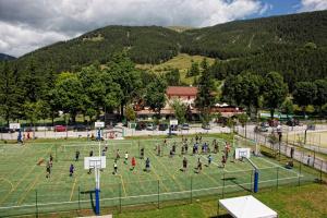 a group of people playing a game on a soccer field at Hotel Bamby in Pescasseroli