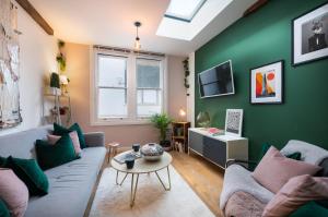 a living room with a couch and a table at 1BR Stylish Flat by HostaraHomes, Near Liverpool Street, Prime London Location, Sleeps up to 4 in London +15 photos