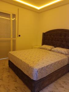 a bedroom with a bed in a room at Appart VIP 2 chambres in Al Hoceïma +5 photos